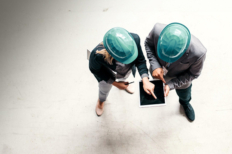 Group in modern office space using Microsoft Surface products at desks